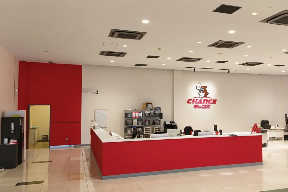 チャンス船橋店の受付カウンターと、壁の犬のマーク